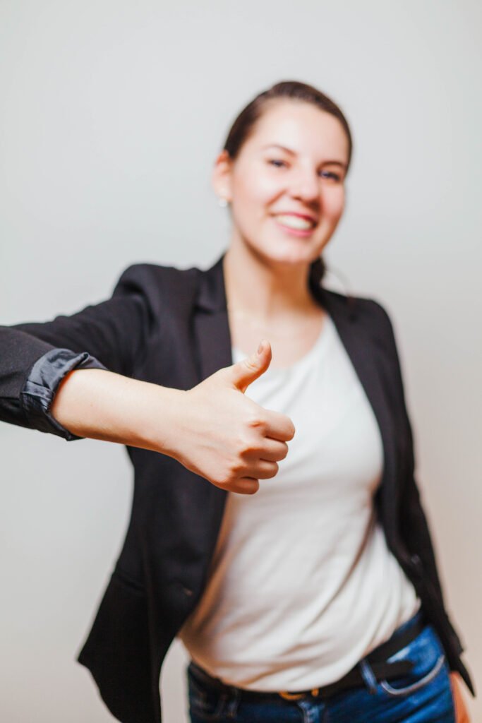 woman formal clothes gesturing thumb up